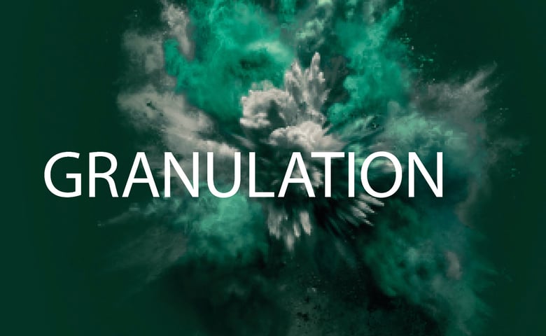 Green-turquoise powder cloud on a dark background with the white text “GRANULATION”.