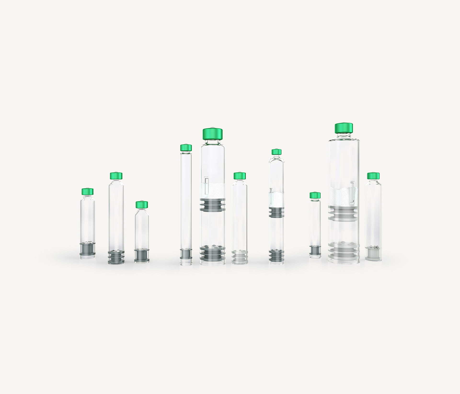 Assorted ready to use cartridges in different sizes with green caps and plungers for injectable products.