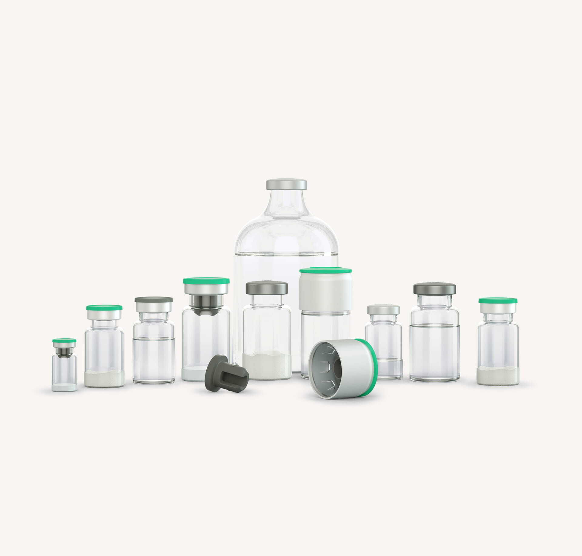 Assorted glass vials in various sizes with grey stoppers and green flip‑off caps for parenteral drugs.