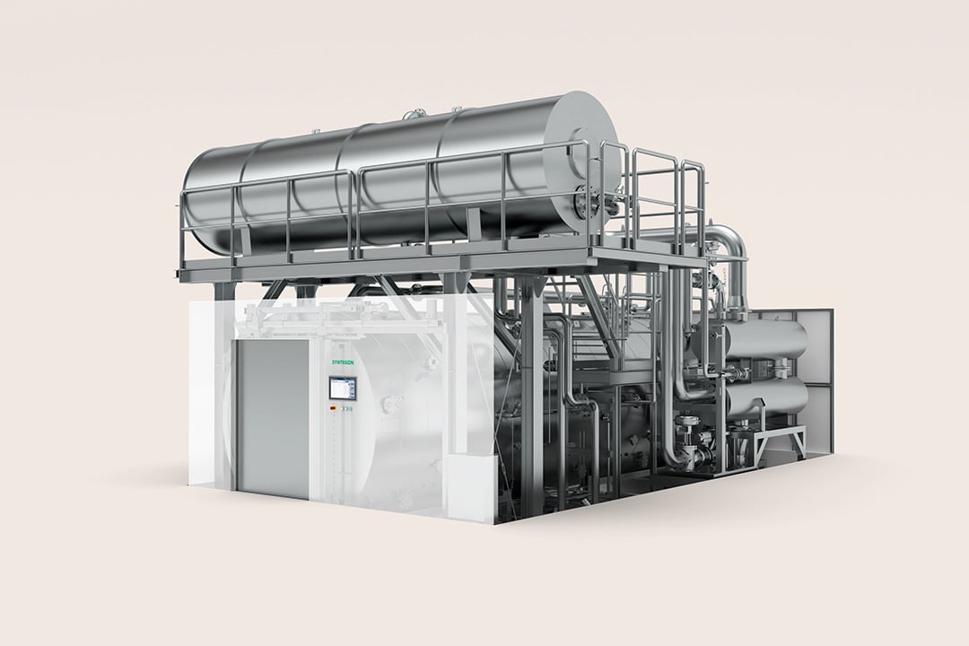 Syntegon Aquatherm hot‑water shower sterilizer with overhead tank and piping; for sealed liquid containers (ampoules, vials); uniform heat via guided water distribution.